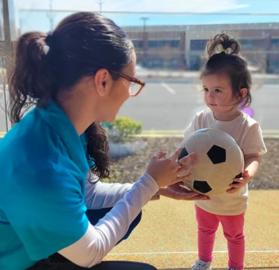 Preschool child having fun with Learning Paths Academy teacher - early childhood education.