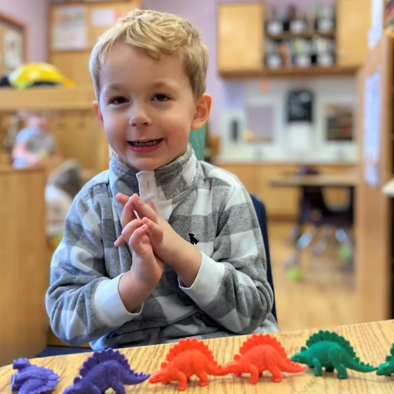 Learning Paths Academy PREP - Preschool Readiness Enrichment Programs - cute young boy learning with dinosaur toys
