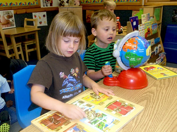 PREP Preschool Readiness Enrichment Program - children learning with a globe and puzzle boards