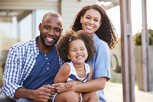 Happy looking African American family with cute smiling child