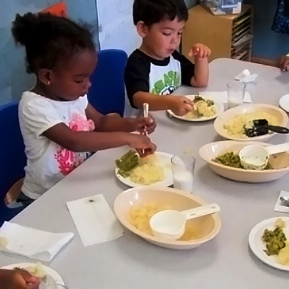 Children eating vegetables together - health, wellness, and nutrition are emphasized at Learning Paths Academy