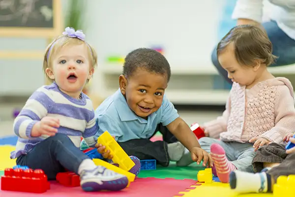 Three smiling toddlers at preschool on the I-81 corridor