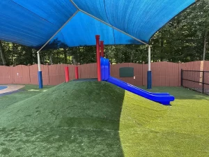 Covered mound with slide on playground at Learning Paths Academy Ashland